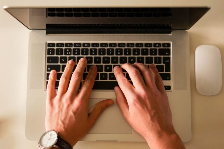 writer typing laptop